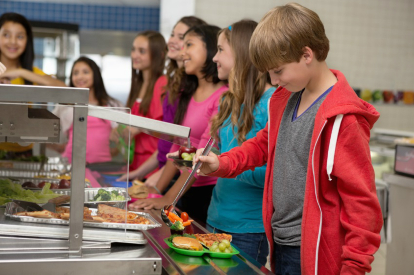 Children serving themselves in a school canteen