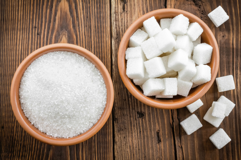 bowl of sugar granules and bowl of sugar cubes
